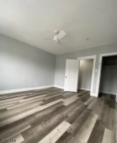 a view of empty room with ceiling fan