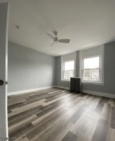 a view of a livingroom with a ceiling fan and window