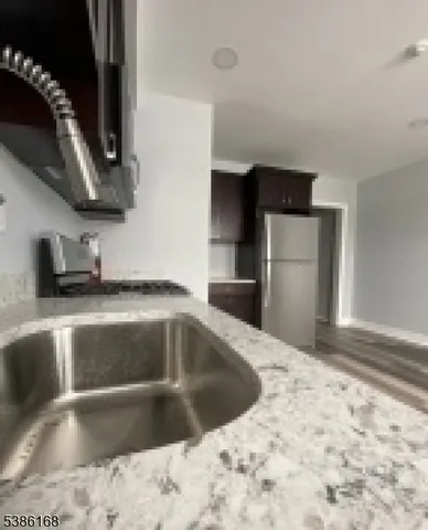 a kitchen with a sink and a refrigerator