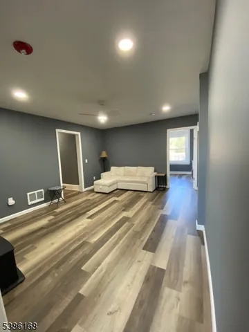 a spacious bedroom with a bed and a lamp