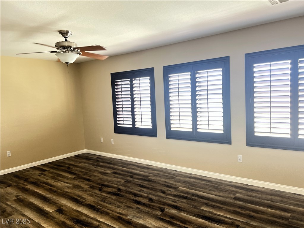 9535 Leaping Lizard Street Las Vegas, NV 89178 - Photo 7 of 37 Primary bedroom with wood-style LVP flooring, ceiling fan, shutters and plenty of natural light