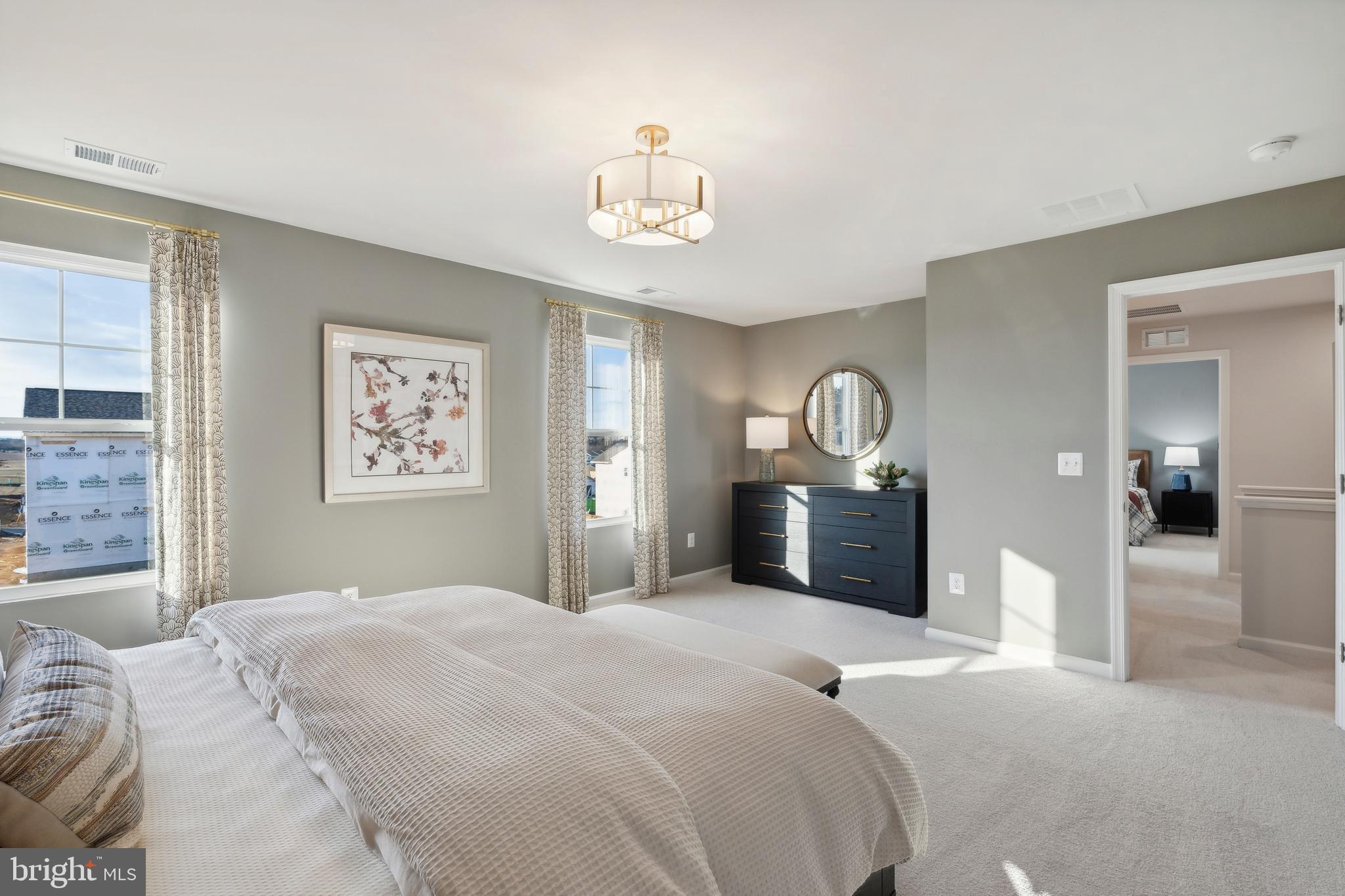 72 Patterson Road Charles Town, WV 25414 - Photo 17 of 32 a bedroom with a bed and a chandelier