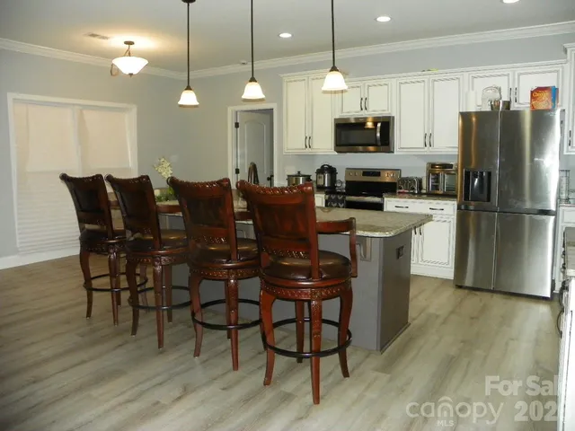 a dining room with furniture and wooden floor