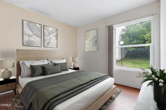 a bedroom with bed and a large window with outer view