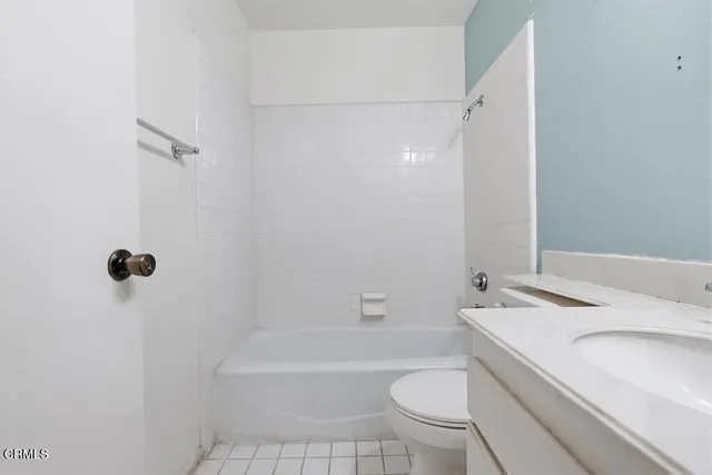 a bathroom with a sink a toilet a mirror and shower