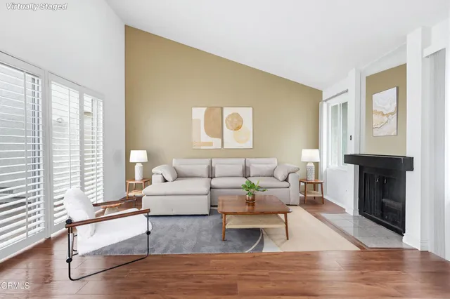 a living room with furniture and a fireplace