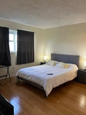 a bedroom with a bed and a window