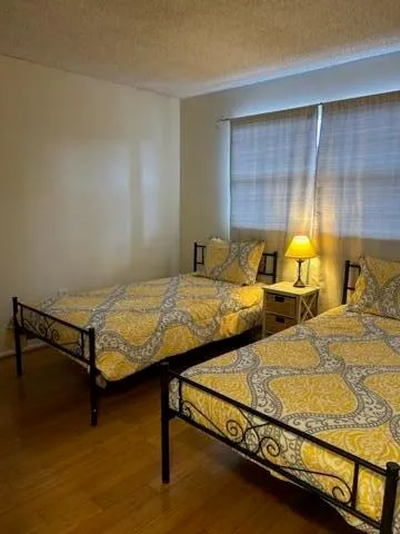 a bedroom with two beds and painted walls