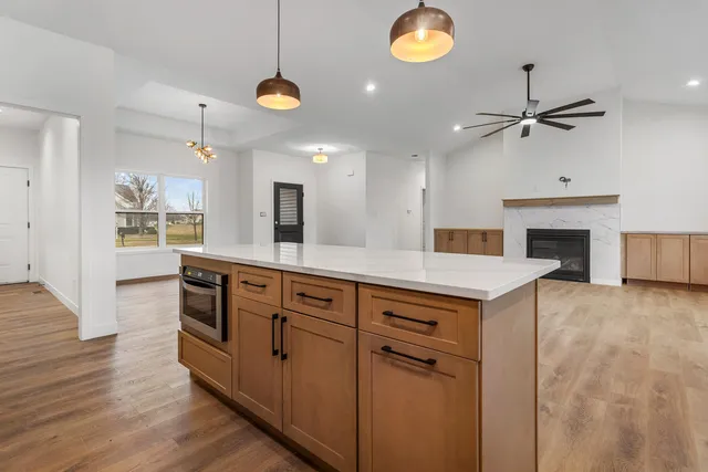 a kitchen with a sink chandelier and a stove