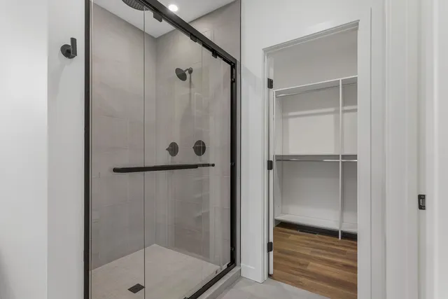a bathroom with a glass shower door