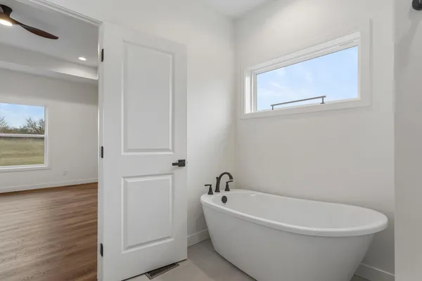 a white bath tub sitting in a bathroom
