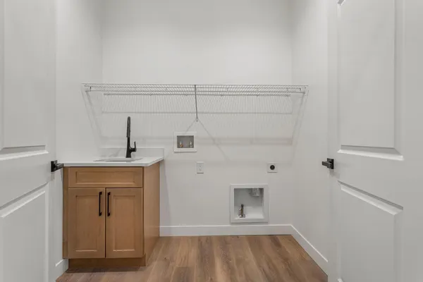 a view of an empty room with closet and a window