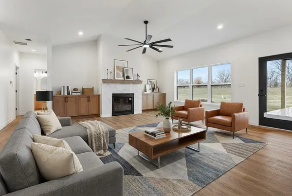a living room with furniture fireplace and window