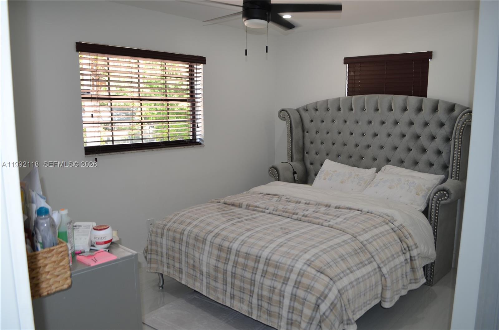 29925 Southwest 143rd Court Homestead, FL 33033 - Photo 12 of 40 a bedroom with a bed and a window