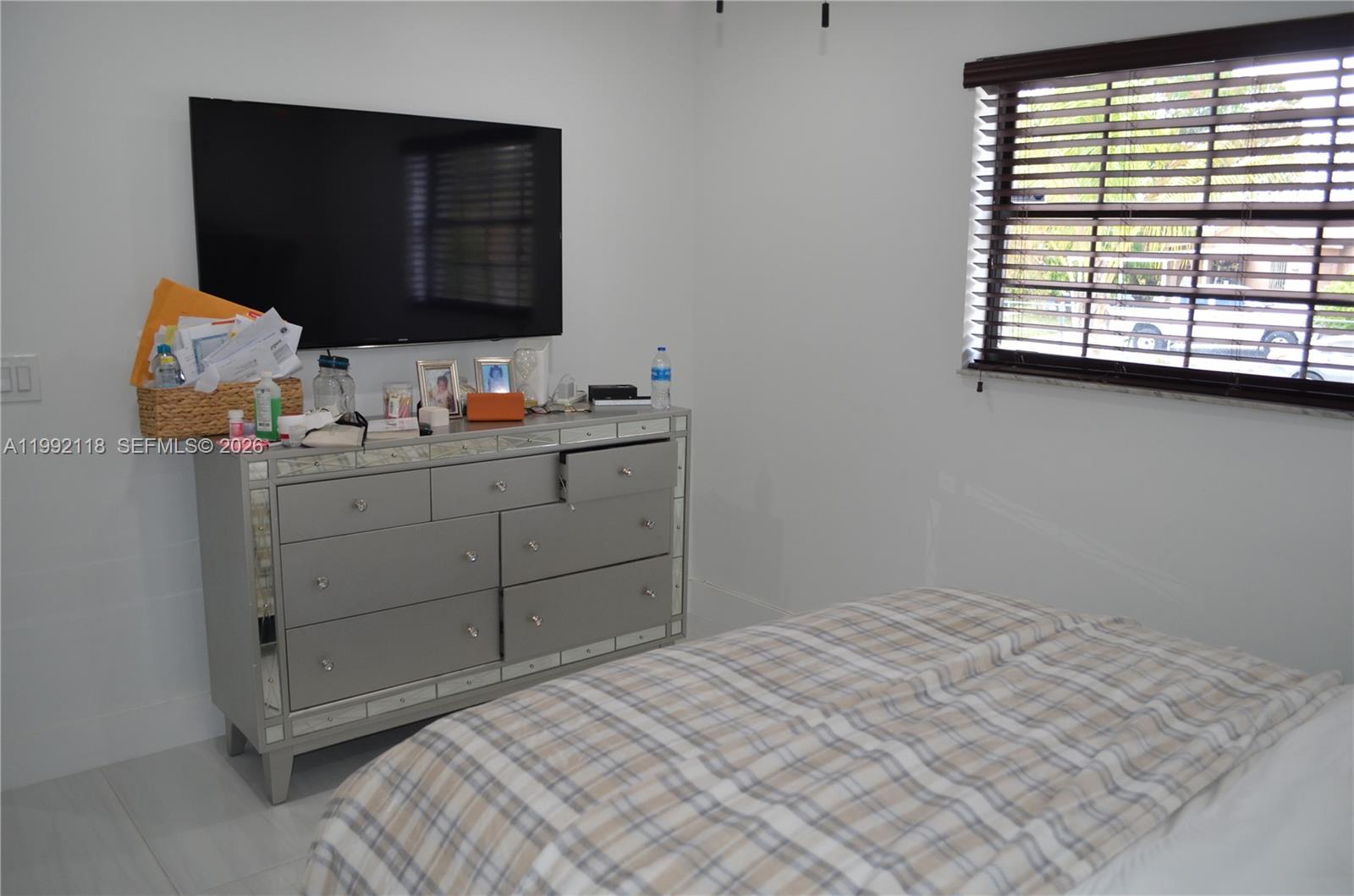 29925 Southwest 143rd Court Homestead, FL 33033 - Photo 13 of 40 a bedroom with a bed and a window
