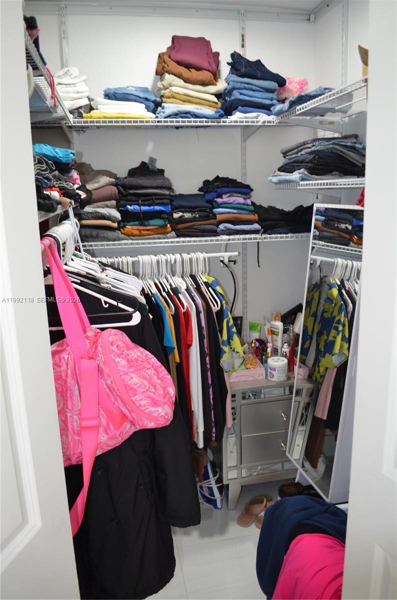 29925 Southwest 143rd Court Homestead, FL 33033 - Photo 14 of 40 a view of walk in closet with clothes and shoes