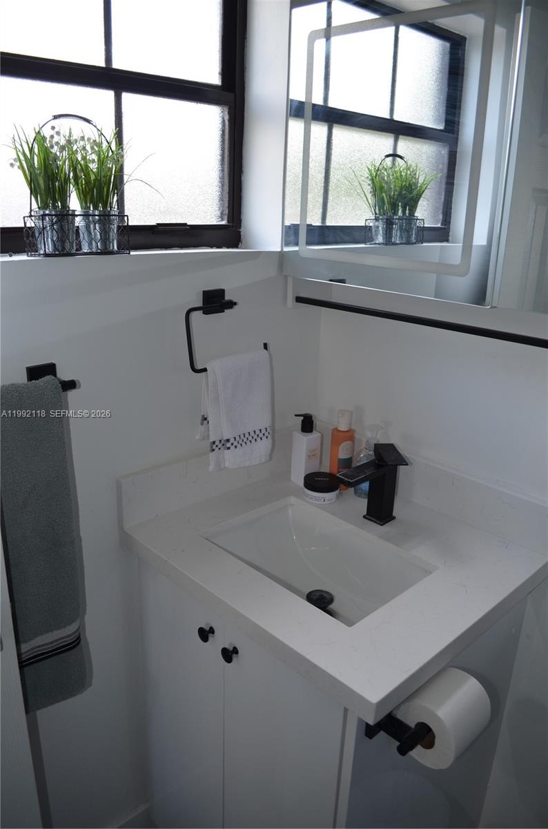 29925 Southwest 143rd Court Homestead, FL 33033 - Photo 15 of 40 a bathroom with a sink and a window