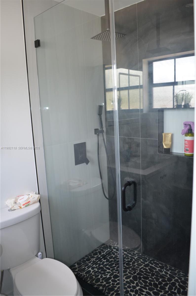 29925 Southwest 143rd Court Homestead, FL 33033 - Photo 16 of 40 a bathroom with a toilet and a shower