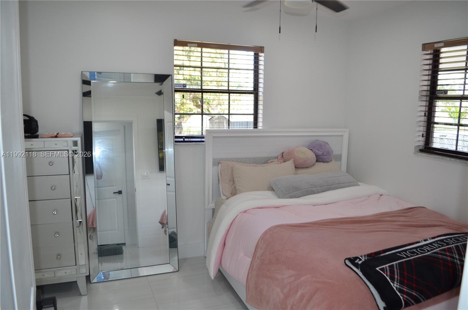 29925 Southwest 143rd Court Homestead, FL 33033 - Photo 17 of 40 a bedroom with a bed and a window