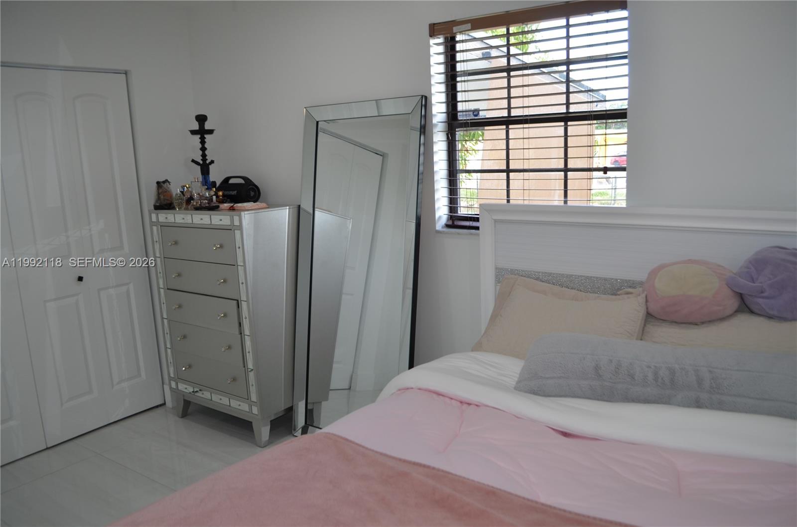 29925 Southwest 143rd Court Homestead, FL 33033 - Photo 18 of 40 a bedroom with a bed and a window