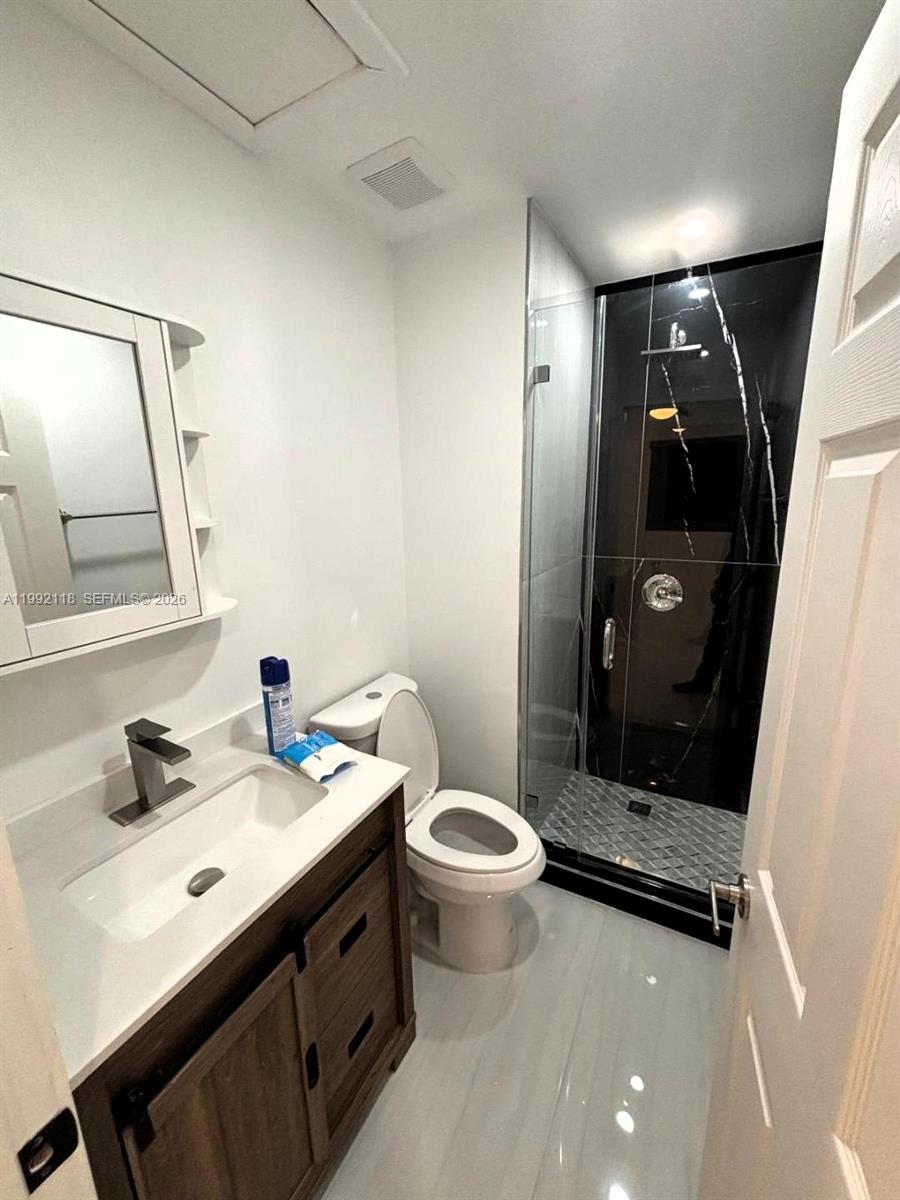 29925 Southwest 143rd Court Homestead, FL 33033 - Photo 20 of 40 a bathroom with a sink a toilet and mirror