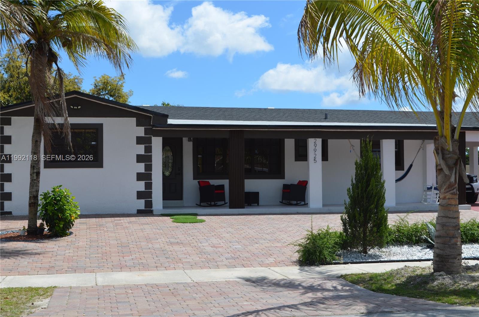 29925 Southwest 143rd Court Homestead, FL 33033 - Photo 2 of 40 a front view of a house with garden