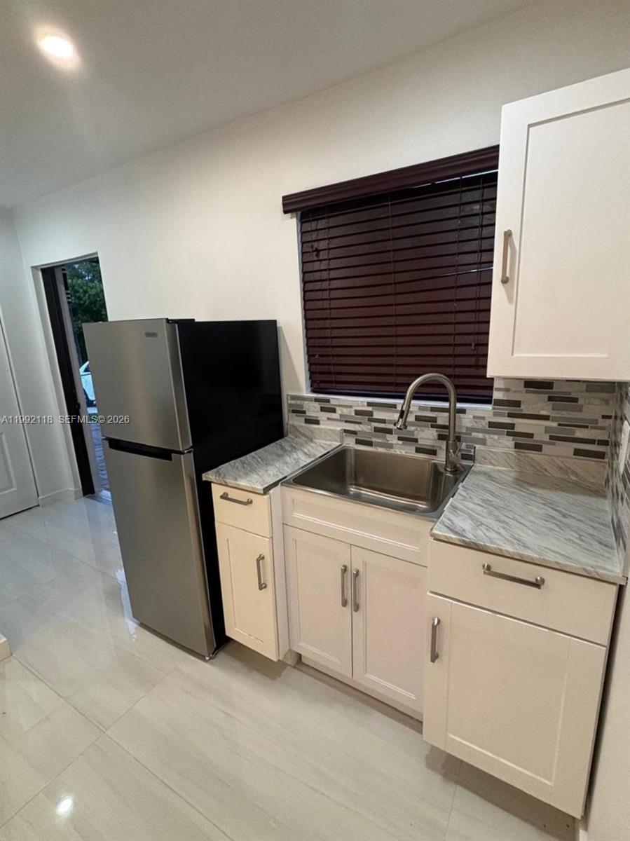 29925 Southwest 143rd Court Homestead, FL 33033 - Photo 21 of 40 a kitchen with stainless steel appliances a sink stove and refrigerator