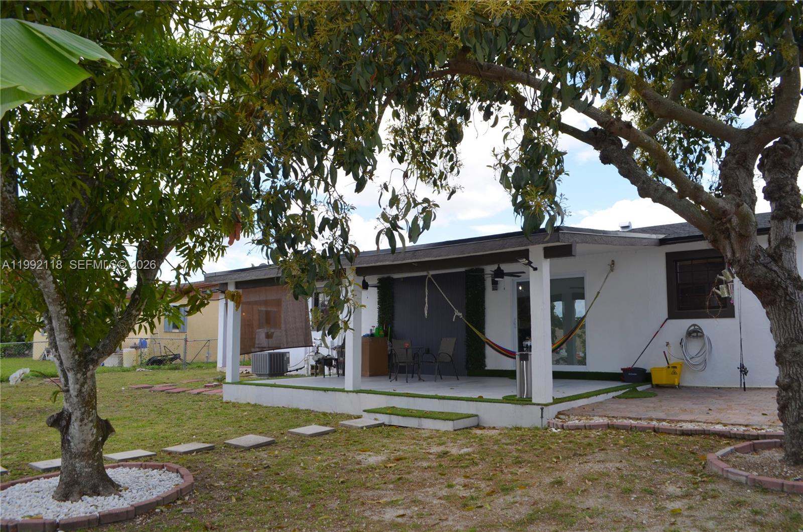 29925 Southwest 143rd Court Homestead, FL 33033 - Photo 25 of 40 a view of a house with backyard and a tree