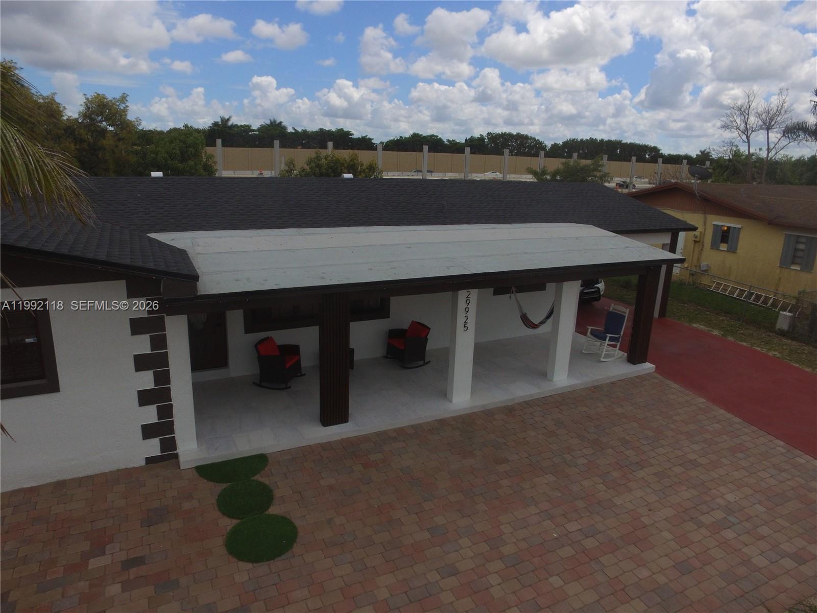 29925 Southwest 143rd Court Homestead, FL 33033 - Photo 35 of 40 a view of a terrace with furniture and a lake view