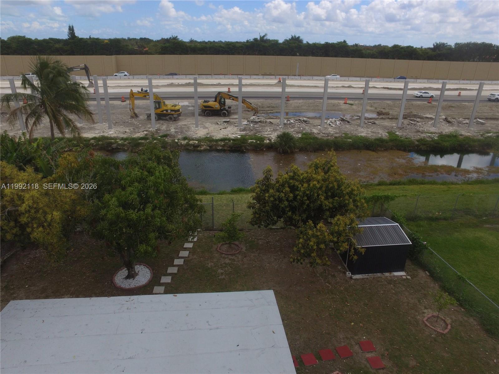 29925 Southwest 143rd Court Homestead, FL 33033 - Photo 37 of 40 a view of a lake with houses in the back
