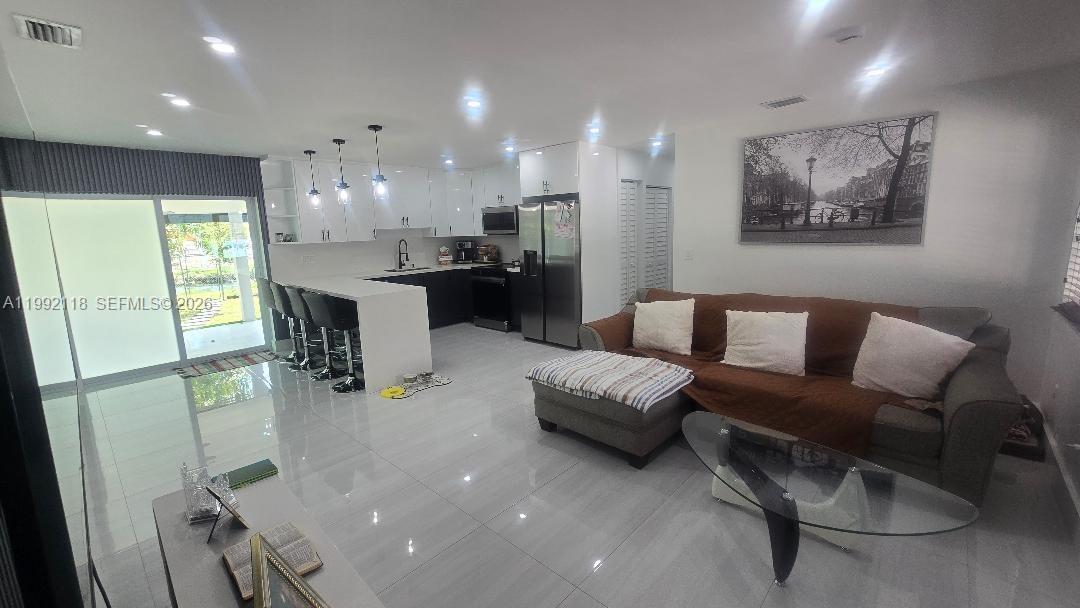 29925 Southwest 143rd Court Homestead, FL 33033 - Photo 39 of 40 a living room with furniture and a kitchen
