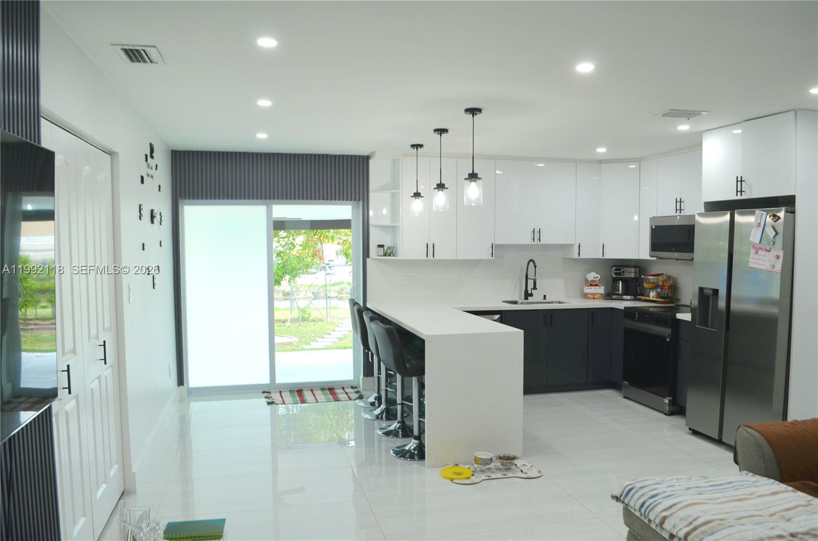 29925 Southwest 143rd Court Homestead, FL 33033 - Photo 4 of 40 a kitchen with a refrigerator and a sink