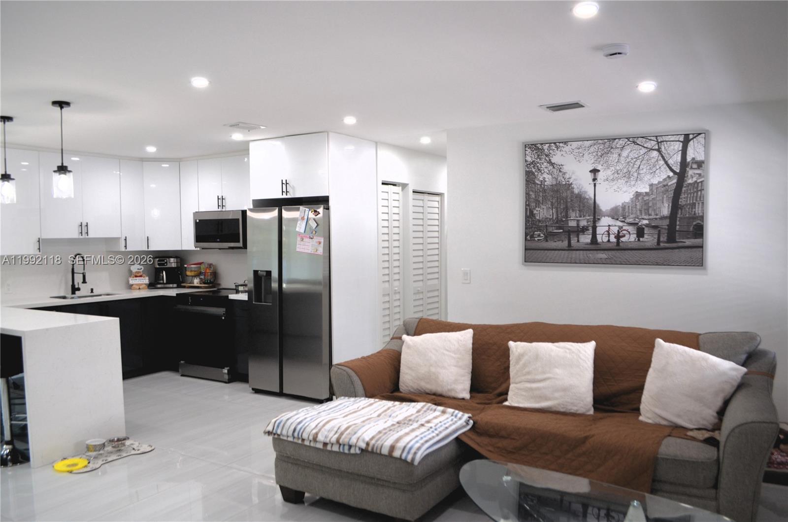 29925 Southwest 143rd Court Homestead, FL 33033 - Photo 5 of 40 a living room with stainless steel appliances furniture and a kitchen view