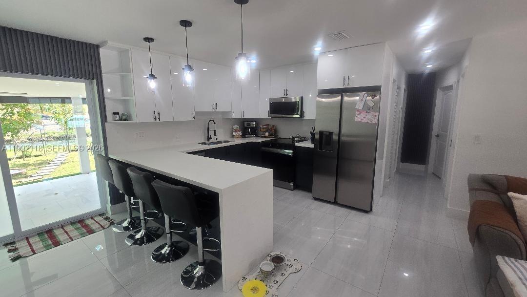 29925 Southwest 143rd Court Homestead, FL 33033 - Photo 7 of 40 a kitchen with refrigerator and window