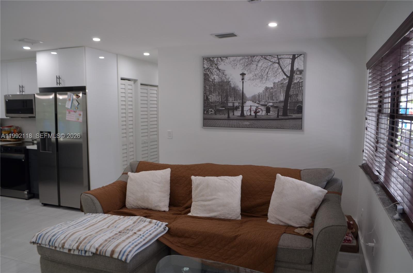 29925 Southwest 143rd Court Homestead, FL 33033 - Photo 10 of 40 a living room with a couch and a painting