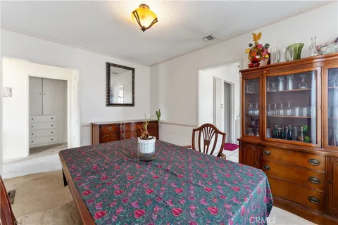 a bedroom with a bed and a large window with the garden view