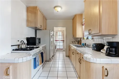 a kitchen with a sink a stove and cabinets