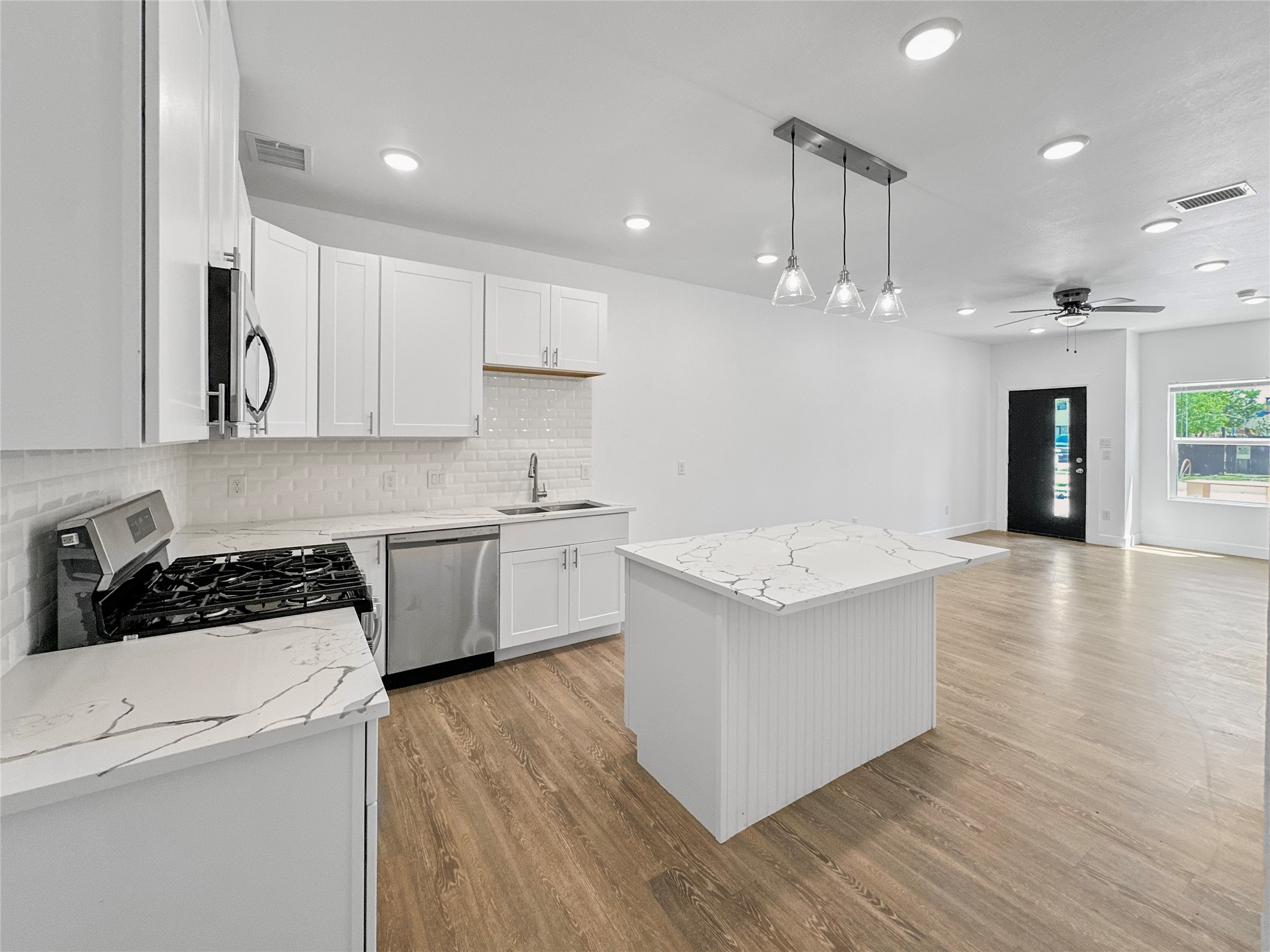 8141 Jeffery Street Houston, TX 77028 - Photo 6 of 27 a kitchen with a stove a sink and a refrigerator