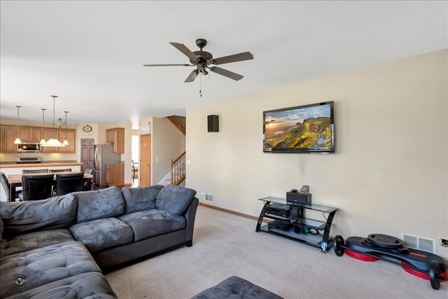 25405 Spring Street Manhattan, IL 60442 - Photo 13 of 36 a living room with furniture and kitchen view