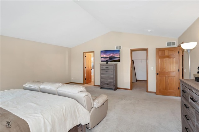 25405 Spring Street Manhattan, IL 60442 - Photo 18 of 36 a spacious bedroom with a bed and cabinets