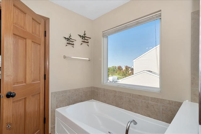 25405 Spring Street Manhattan, IL 60442 - Photo 20 of 36 a bathroom with a tub and a view of a bathroom