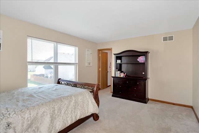 25405 Spring Street Manhattan, IL 60442 - Photo 22 of 36 a bedroom with a bed and window