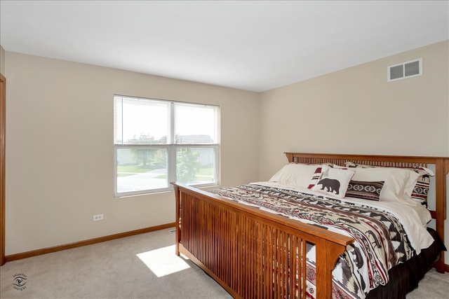 25405 Spring Street Manhattan, IL 60442 - Photo 23 of 36 a bedroom with a bed and a window