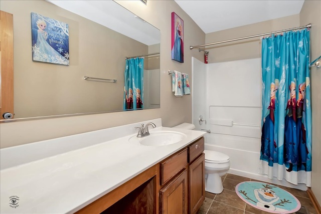 25405 Spring Street Manhattan, IL 60442 - Photo 27 of 36 a bathroom with a sink a toilet and shower curtain