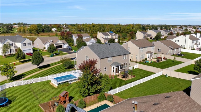 25405 Spring Street Manhattan, IL 60442 - Photo 6 of 36 an aerial view of a house with a garden and lake view