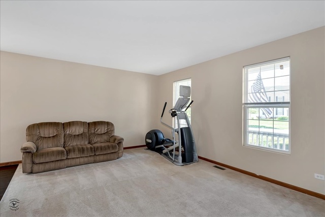 25405 Spring Street Manhattan, IL 60442 - Photo 9 of 36 a room with gym equipment and a window