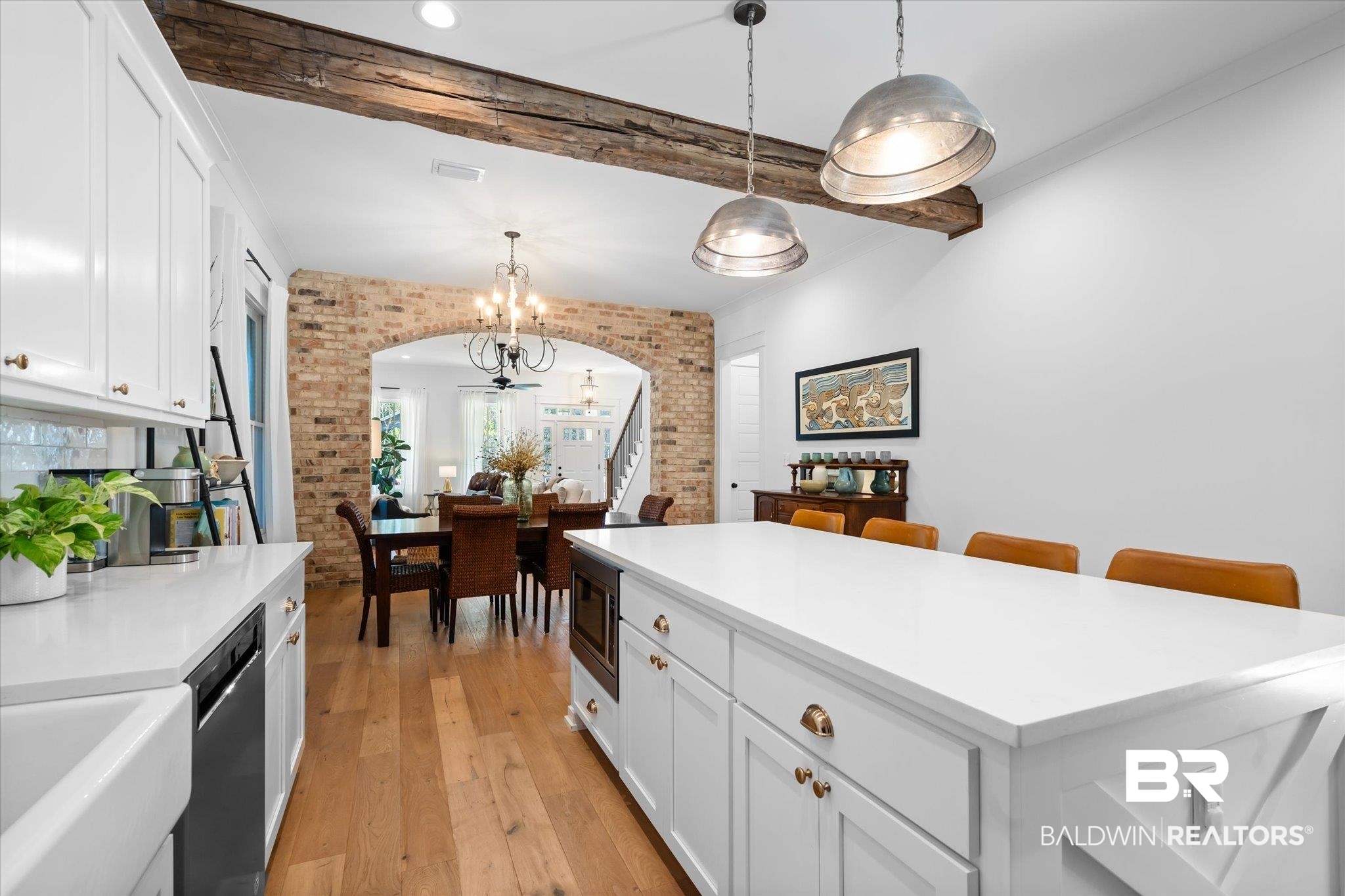 15 Semmes Avenue Mobile, AL 36604 - Photo 11 of 43 Kitchen with appliances with stainless steel finishes, pendant lighting, white cabinetry, and brick wall