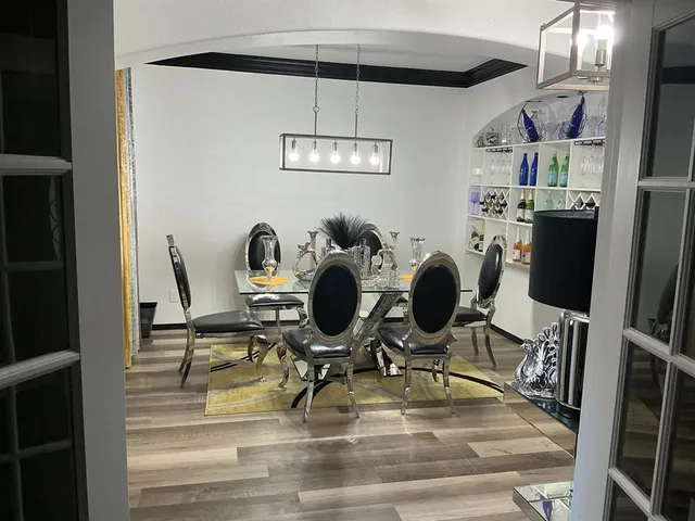 a view of a dining room with furniture and a chandelier