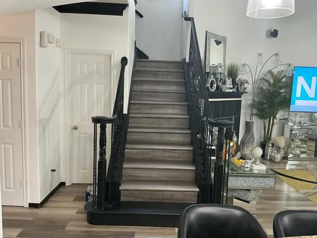 a view of entryway and hall with wooden floor