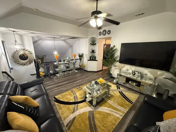 a living room with furniture and a flat screen tv